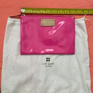 Kate Spade hot pink vinyl zippered pouch.